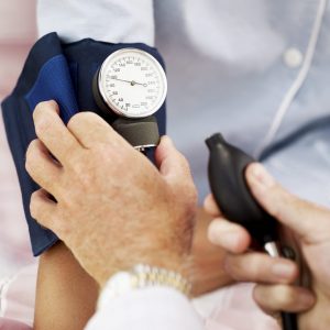 Pair of Human Hands Checking the Blood Pressure of a Patient